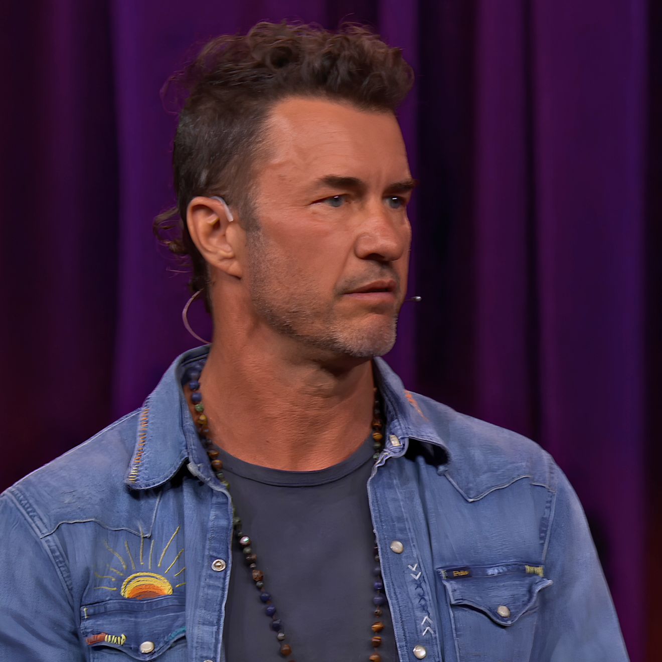 Blake Mycoskie speaking on the TED stage about depression and the three words that saved his life